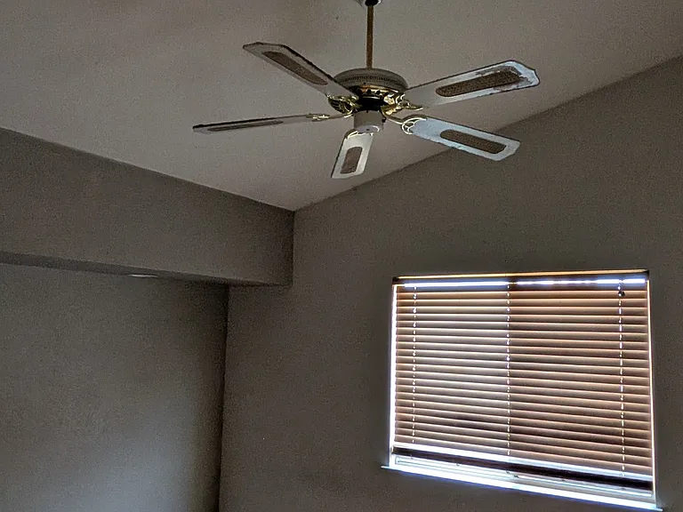 Bedroom 2 (upstairs) with window overlooking backyard