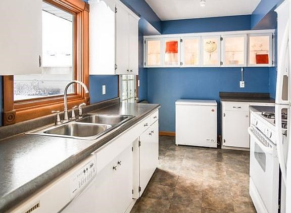 Then turn the corner and head into the kitchen. Notice the glass front, lighted cabinets on the far wall. Place your favorite china, artwork or photos here for a great display!