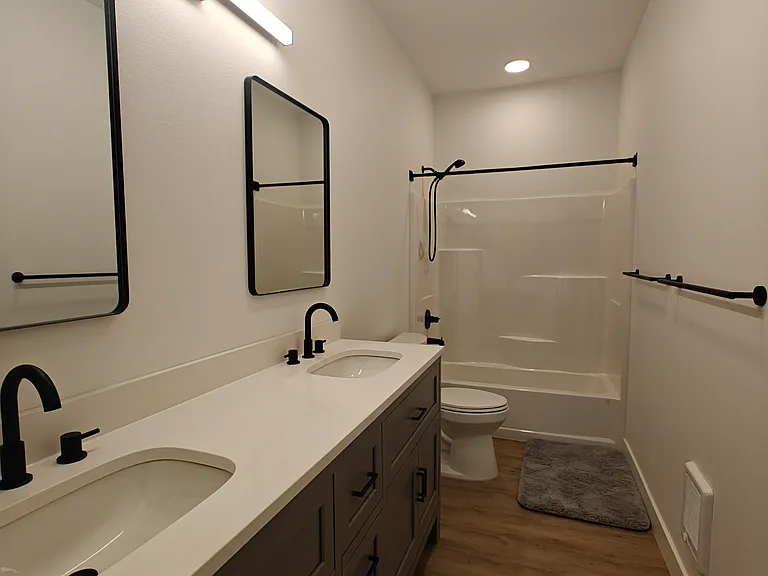 Double vanity Kohler bathroom with brand new Kohler fixtures and countertops. Inside drawers have built in outlets.