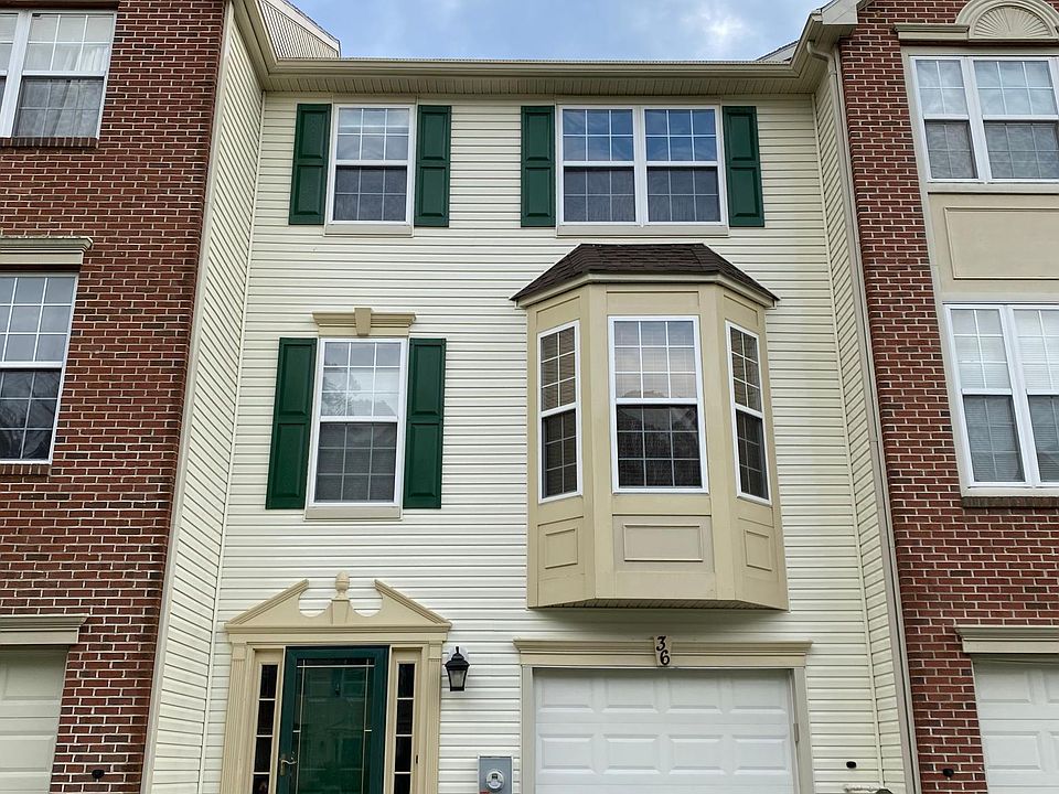 3 story townhouse with one car garage and one car space in driveway