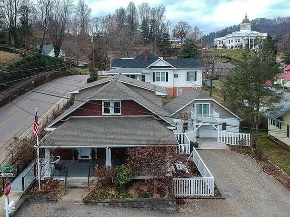 Arial view of property with cottage on right. Courthouse upper right in background.