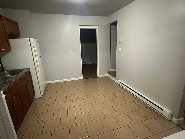 Kitchen leading to basement bedroom