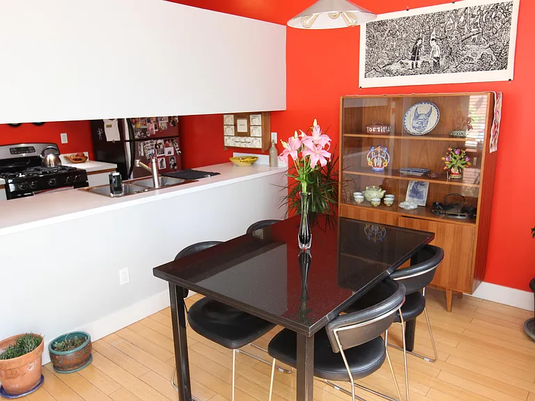 Kitchen and dining room. The kitchen also features the door to the backyard.