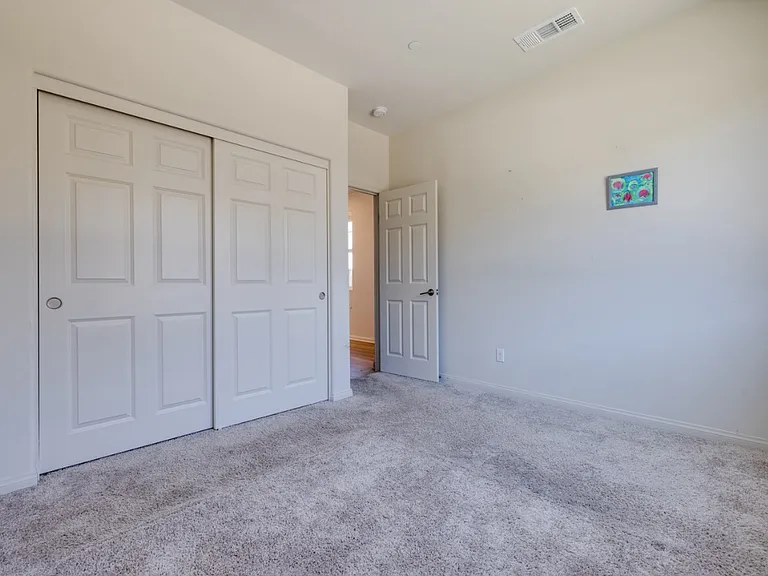 Downstairs bedroom facing east toward Brightstone Street, offering easy access to the main entrance, guest bathroom, and living area. Provides full privacy from the upper floor, making it ideal for guests, in-laws, or a private home office.