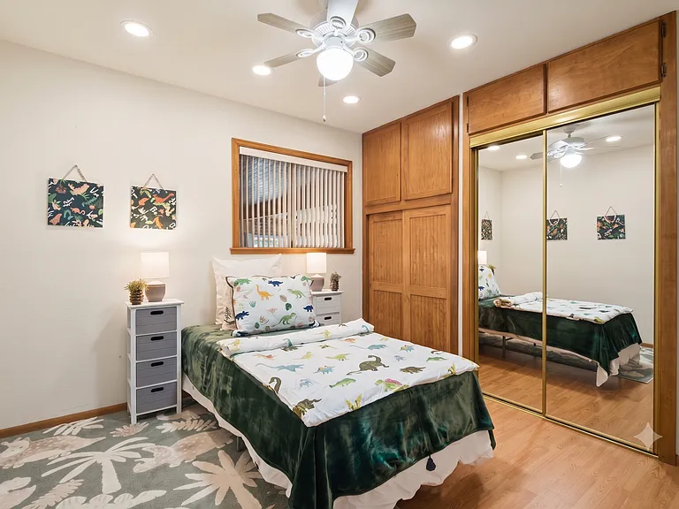 Floor-to-ceiling built-in closet with upper storage cabinets