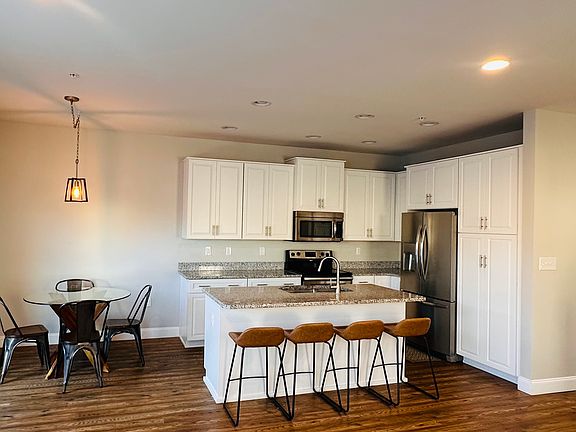Eat in kitchen table and barstools can stay if desired