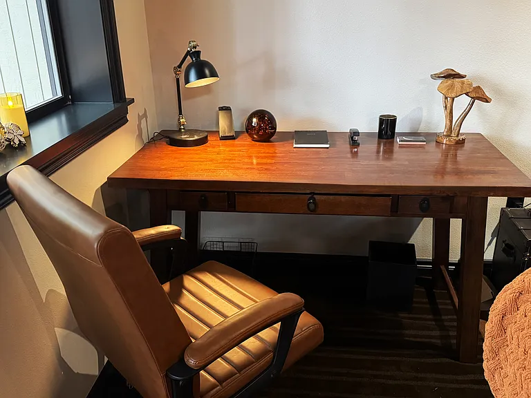 Dedicated workspace with desk, leather chair and high speed WIFI ideal for remote and professional work.
