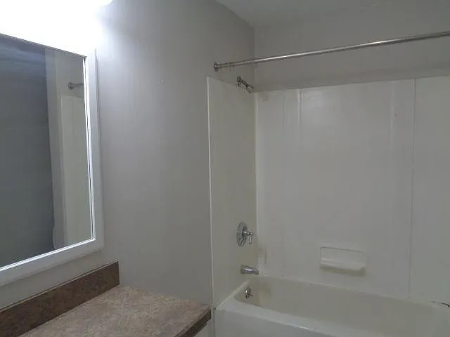 Bathroom 2 - has a tub/shower, toilet, vanity, and pedestal sink.