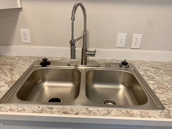 New kitchen with new dishwasher, microwave, oven, sink, and lots of cabinet space.