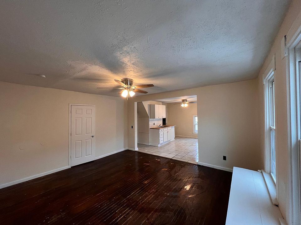Living room facing second bedroom and kitchen