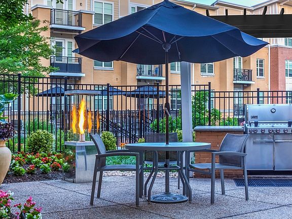 Poolside, outdoor lounge with seating and gas grills