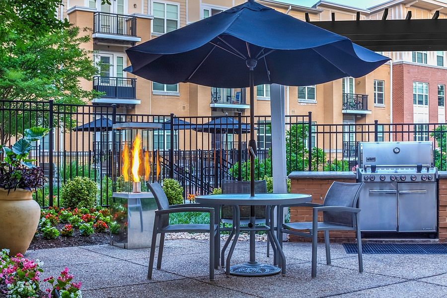 Poolside, outdoor lounge with seating and gas grills