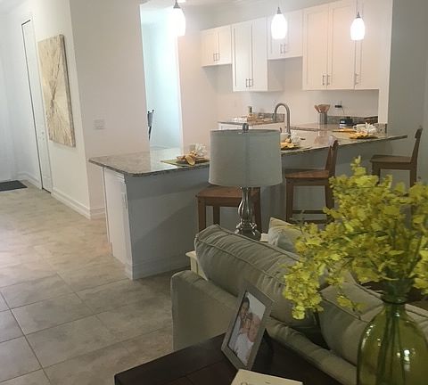 Entryway, kitchen, and partial livingroom views