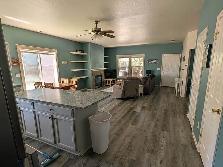 Open-plan layout of kitchen, dining area, and living room