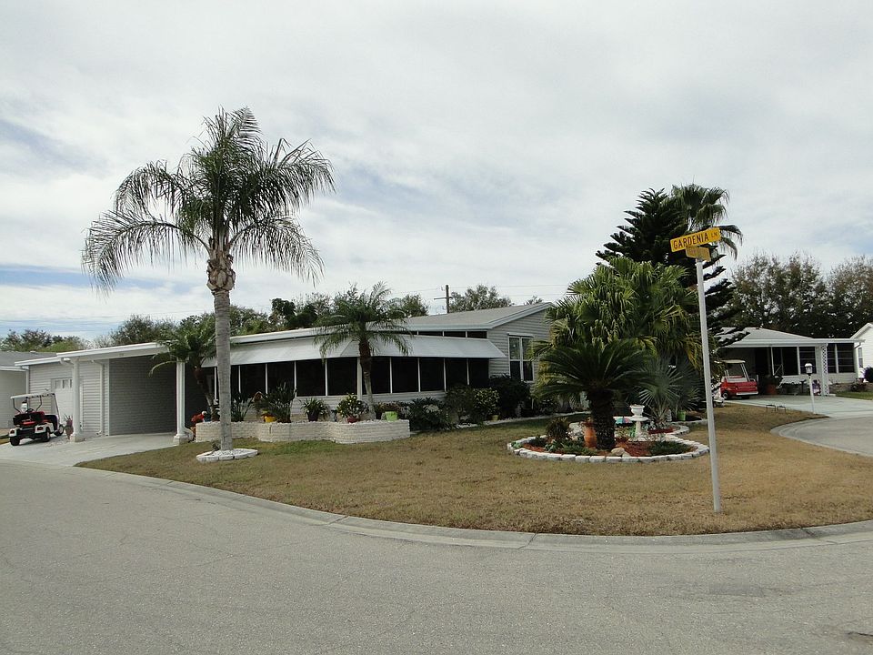 Home with 20x20 lanai, garage with plenty of storage space AND 2 car carport