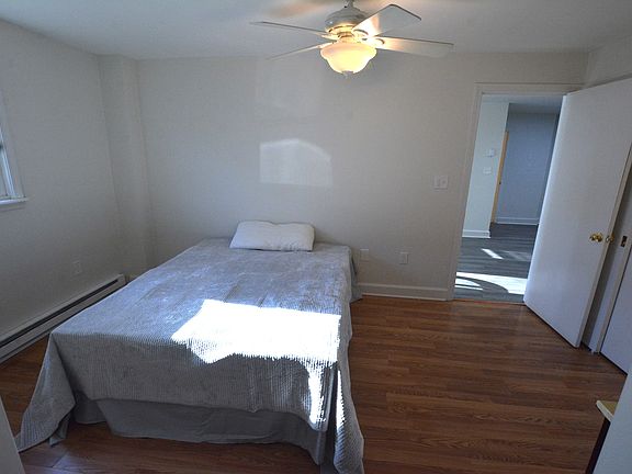 Bedroom with queen bed and dresser