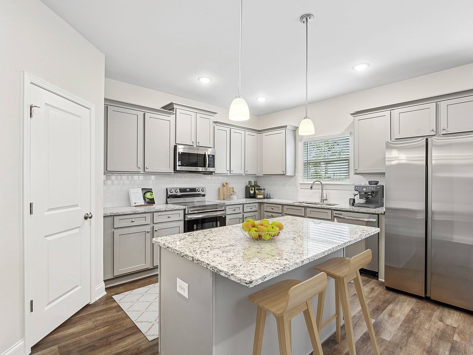 Another view of the spacious kitchen and stainless steel appliances