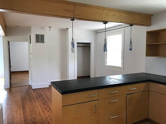 View from the kitchen into the living room. The open door is the bedroom.