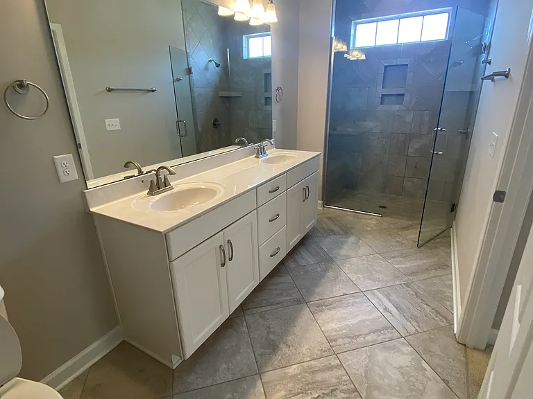 Master bathroom, double vanity and walk-in shower, plus linen closet