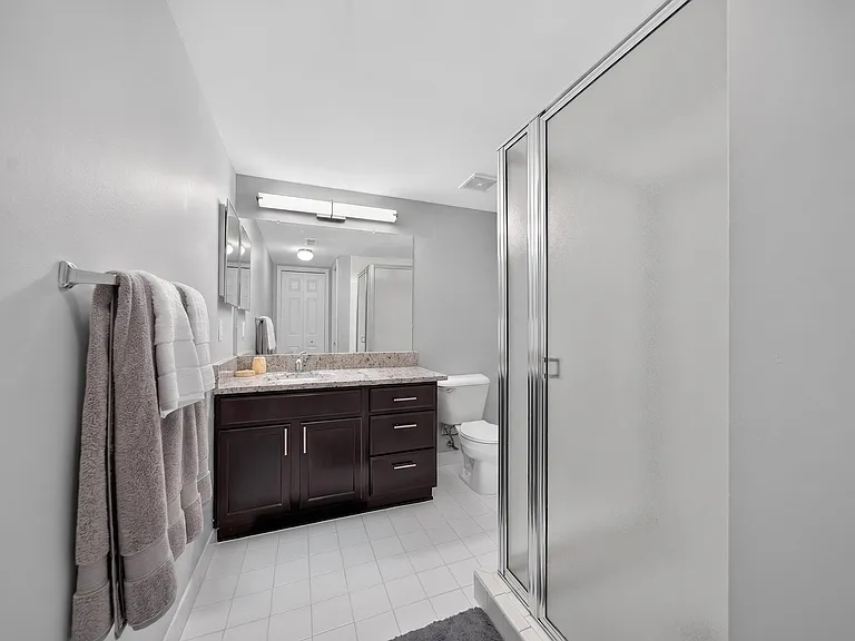 Bathroom with Shower and Ample Storage at Lakeside Village Apartments in Clinton Township, MI