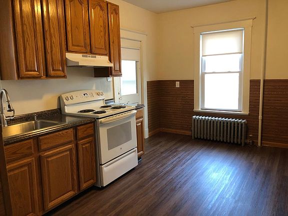 Rear entry to kitchen. New floors, sink, countertop.