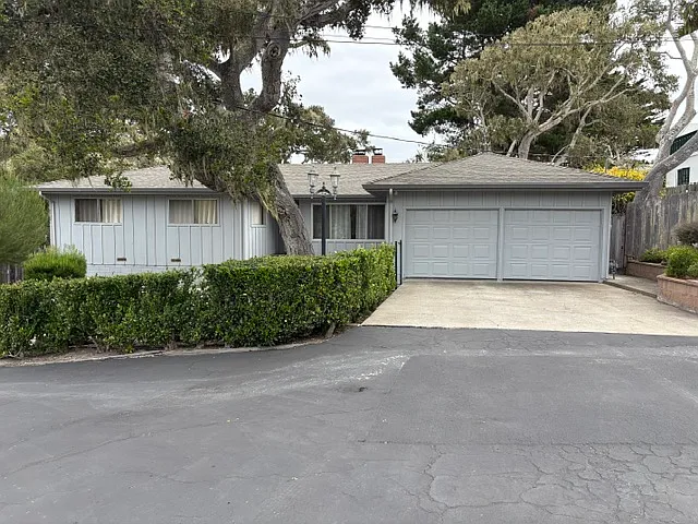 Two car garage with cement and asphalt driveways, sweep driveway is in asphalt.