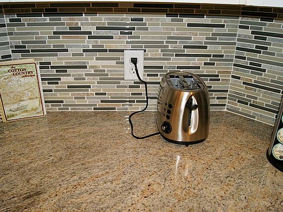CUSTOM GRANITE COUNTER TOPS AND GLASS TILE BACK SPLASH