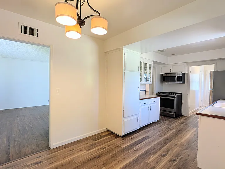 View of kitchen and living room from dining area