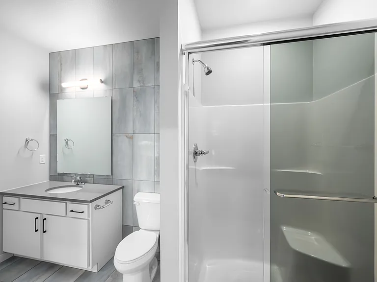 Sleek and modern bathroom featuring a stylish vanity, spacious shower, and elegant lighting. Sleek and modern bathroom featuring a stylish vanity, spacious shower, and elegant lighting.