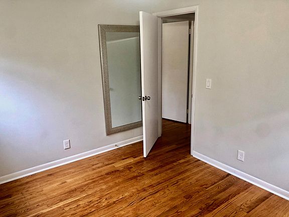 Bedroom # 2, has a ceiling fan, two windows, closet and mirror.