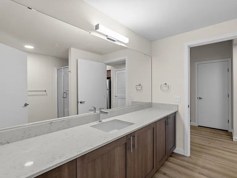 Spacious bathroom with sleek finishes and generous counter space. Spacious bathroom with sleek finishes and generous counter space.