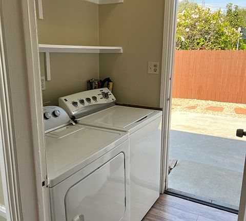 Side by side washer and dryer off the kitchen. Door leads out to the drought tolerant backyard.