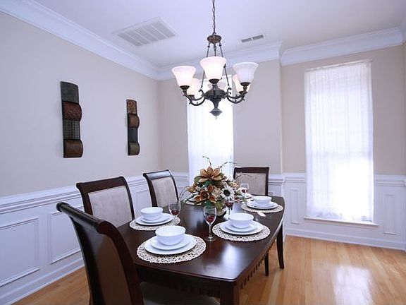 Arched entry leads to formal dining room with hardwood & beautiful molding
