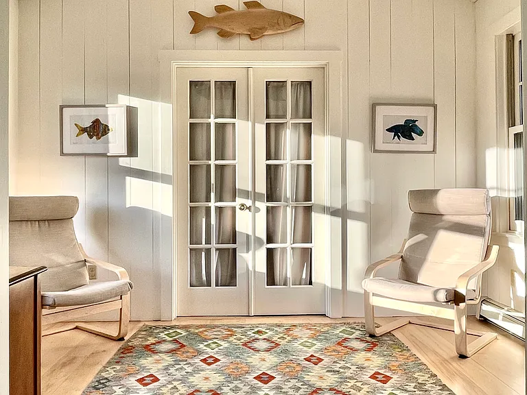 The Library with French doors to the "Cottage," a separate living area with itsa own entrance, large screen TV, living room, kitchenette, bedroom, and bath.