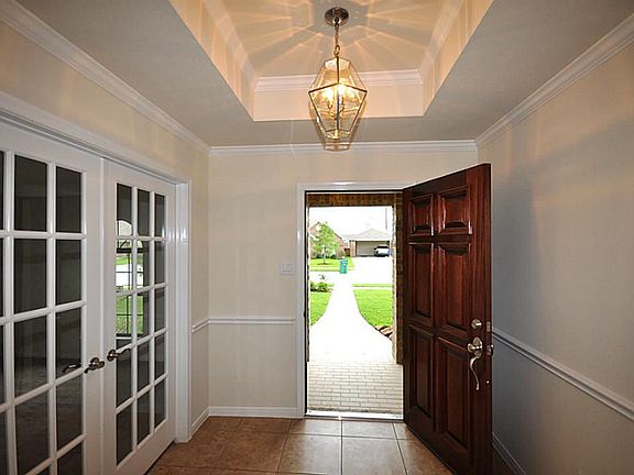 Foyer with French Doors into the Study and an inviting tray ceiling.
