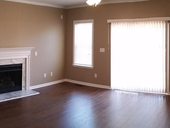 Large Living Room features gas fireplace, all wood floors, sliding glass door out to deck out back. Quiet and private backyard. Mud room and large laundry room off garage entry, leading to Living Room.