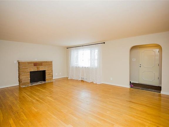 The family room is a massive space with the stone decorative fireplace as the focal point.