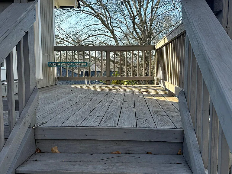 Stairs leading to entrance and front porch