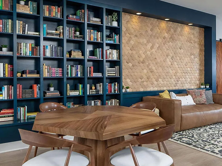 Resident Clubroom Featuring Built-In Bookshelves, Lounge Sofa, and Reading Table