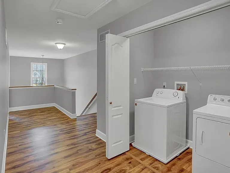 Upstairs landing zone that is open to the foyer and has the washer and dryer.