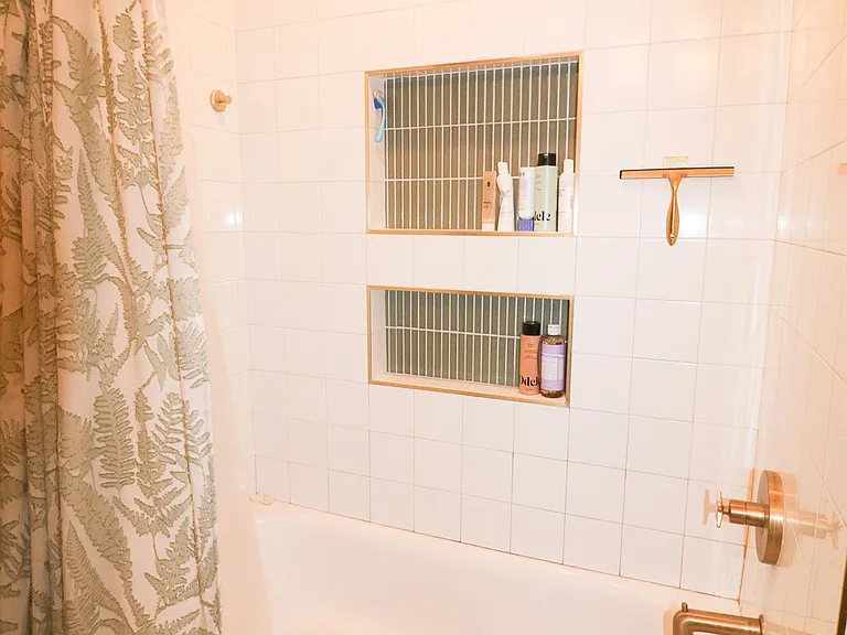 Brand new tub and shower with hot water and ample storage space