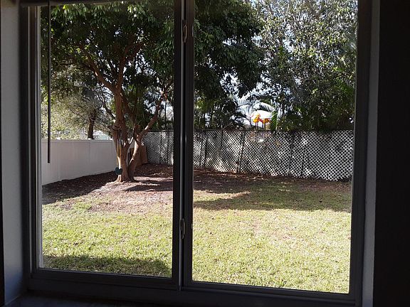 View from kitchen to large, fully-fenced back yard.
