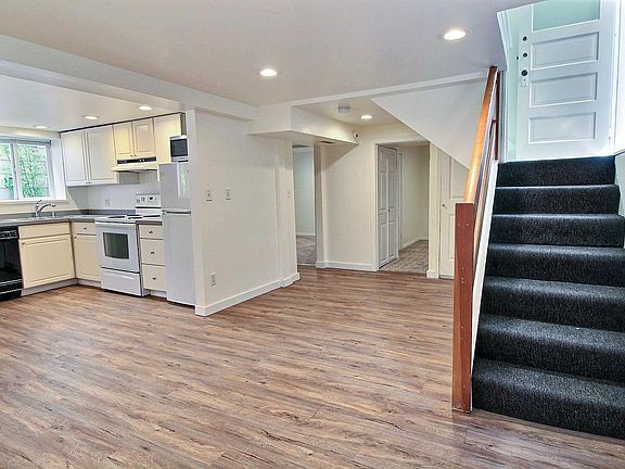 Bedroom with egress window and bathroom to the left and on the right is the den/office room with laundry closet.