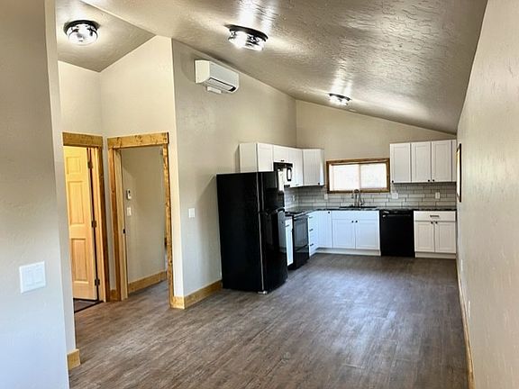 Open kitchen, living, and mud room/laundry area