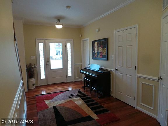 Foyer with crown molding and wainscoting