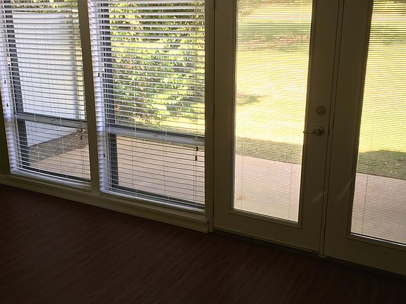 Living Room/Dining Room with French doors looking out to patio area.