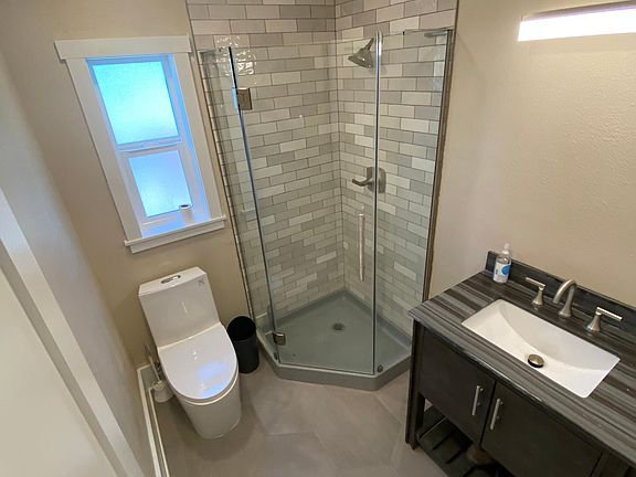 Brand new bathroom with tile and new toilet and vanity.