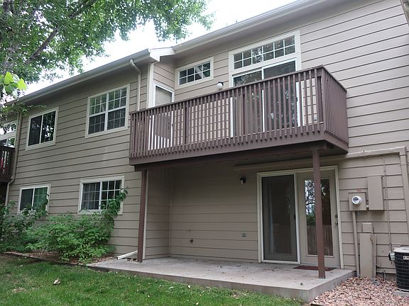 Back of townhouse-balcony and walk out patio.