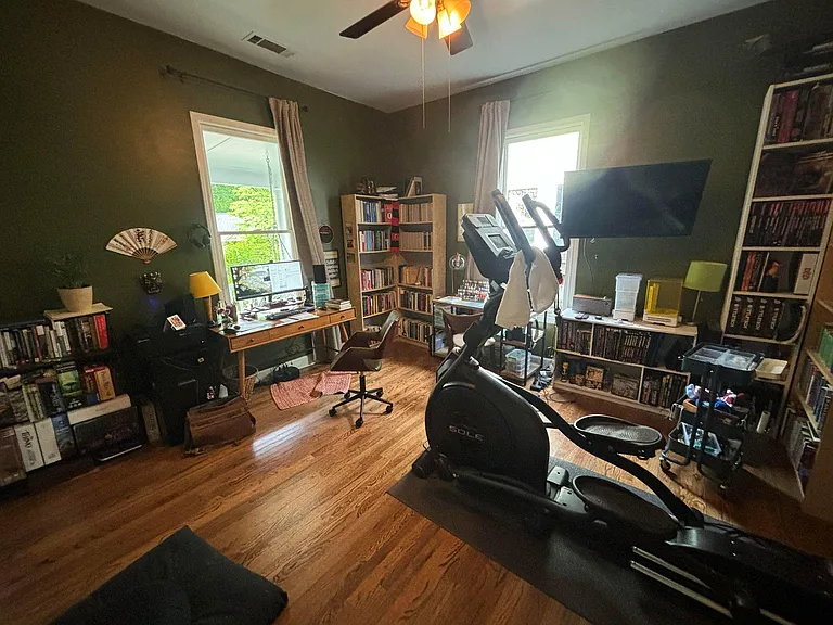 Bedroom 1 in front of the house. Two large windows. Has inoperable but charming fireplace