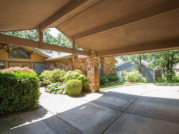Vaulted Porte Cochere beautifully frames the interior courtyard and provides for a weather-protected arrival via car.